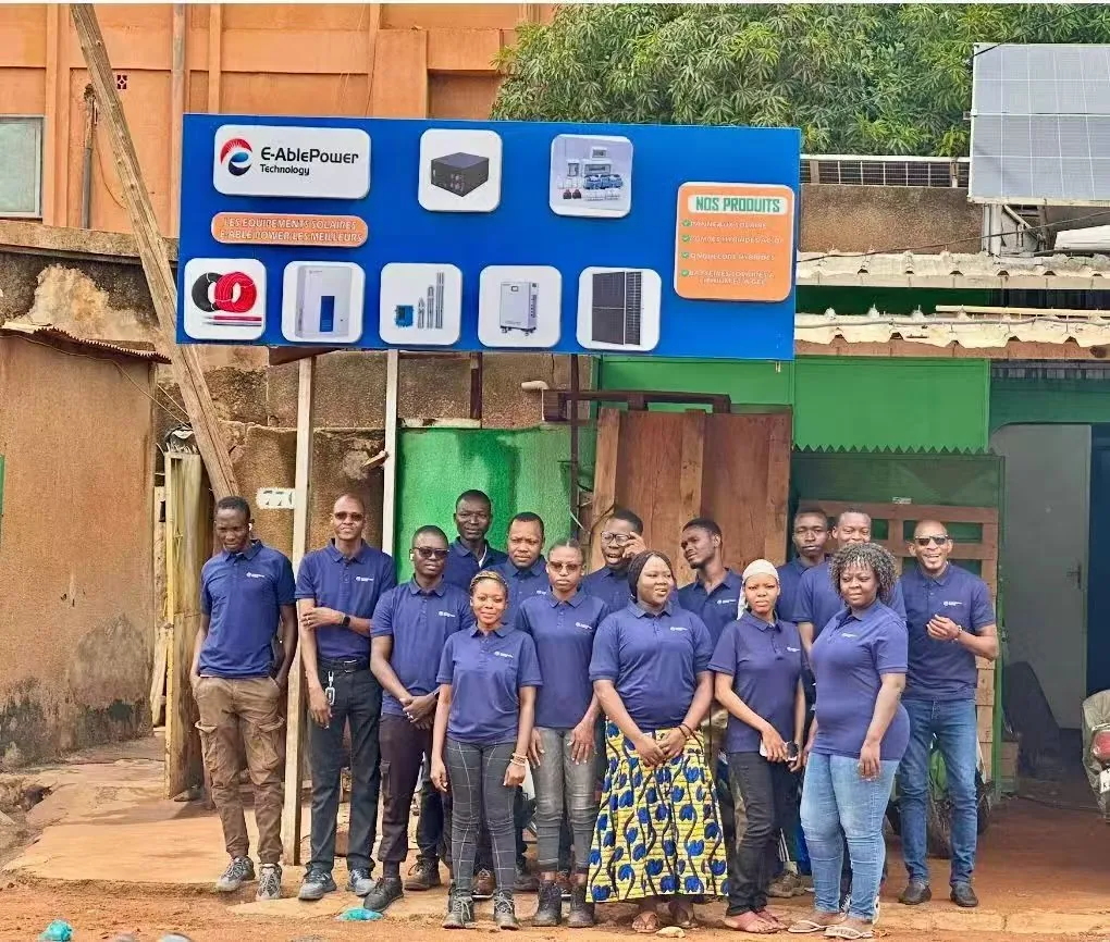 E-Able Power overseas partner team in front of the E-AblePower Technology storefront in West Africa