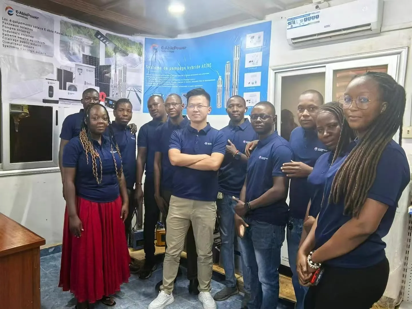 E-Able Power distributor team in the solar showroom with E-AblePower product posters